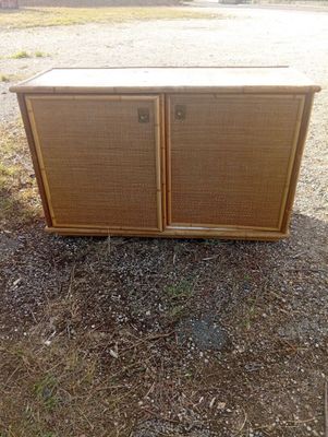 an old radio sitting on top of a grass covered field