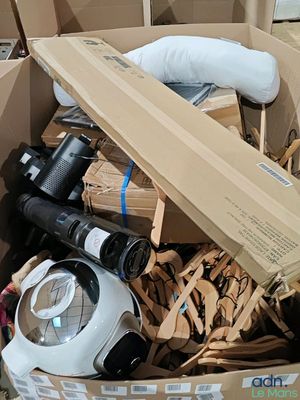 a cardboard box full of assorted items in a room