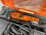 an orange electric drill in a tool box