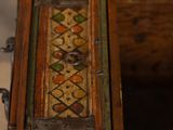 an old wooden box with a decorative design on the inside