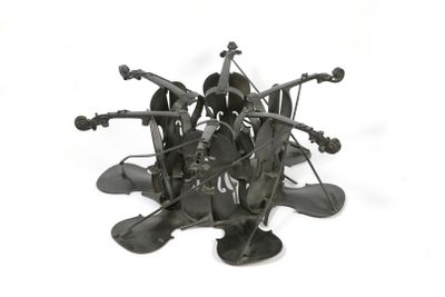 a metal sculpture of a bunch of objects on a white surface