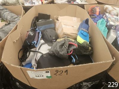 a cardboard box filled with assorted items on the ground