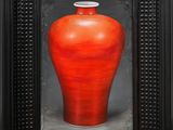 a painting of a red vase in a black frame