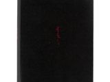 a black book with red writing on it sitting on top of a white surface