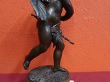 a statue of an angel holding a sword on a pedestal
