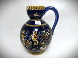 a blue vase with a gold decoration on it