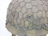 a close up of a helmet with a chain around it