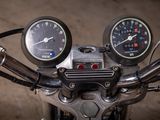 two gauges on the handlebars of a motorcycle