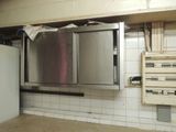 an image of a kitchen with a refrigerator and cabinets