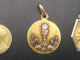 three gold and silver lockes with a woman ' s face on them