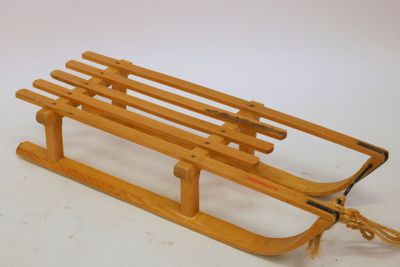 a wooden sled with a rope attached to it