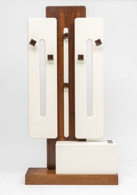 a white and brown sculpture on a wooden stand