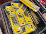 many different tools in a box on the floor