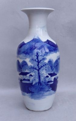a blue and white vase sitting on a white surface