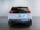 the rear end of a white car in a white room