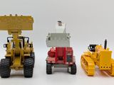 two toy vehicles that are sitting next to each other