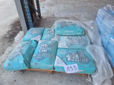 several bags of cement sit on a pallet in front of a pallet