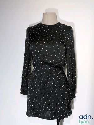 the dress is black and white with white dots on it