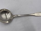a close up of a spoon with a spoon handle on a table