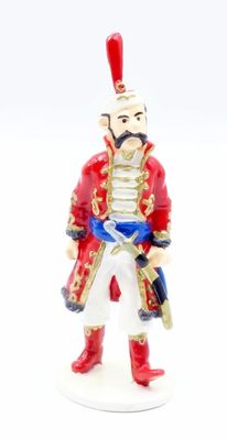 a figurine of a man in a red uniform