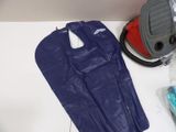 a blue bag and a vacuum on a white table
