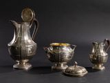 three silver vases sitting next to each other on a table