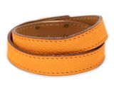 a close up of an orange leather bracelet on a white background