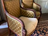 two chairs in a room with a rug on the floor