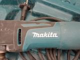 a corded drill in a tool box with a cord
