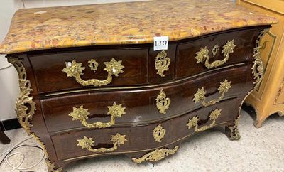 a marble top chest of drawers on display in a store