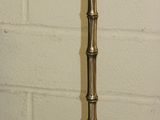a tall metal pole with a light on top of it