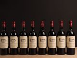 six bouteilles de vin sont alignées sur une table