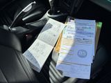 a pile of papers sitting on the seat of a car