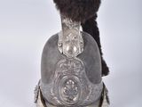a silver helmet with a fur ball on it