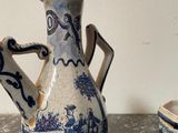 a blue and white tea pot and a cup on a table