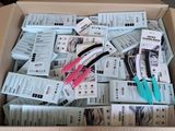 a cardboard box filled with scissors and a bunch of coupons