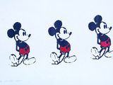 three mickey mouses are standing in a row on a white surface