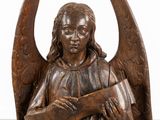 an image of a statue of an angel holding a book