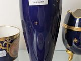 three vases sitting on a glass shelf next to each other