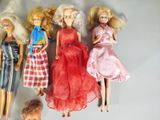 five dolls that are lined up together on a table
