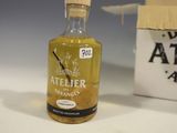 a small bottle of alcohol sitting next to a box
