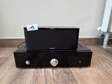 a black amplifier sitting on top of a wooden floor