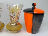 three vases sitting next to each other on a table
