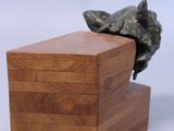wooden box with a statue of a dog on top of it