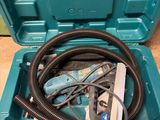 a blue tool box with a hose in it on the floor