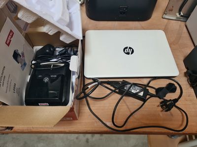 a laptop computer sitting on top of a wooden table