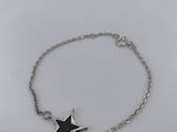 a silver bracelet with a black star on it