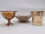two silver vases and a silver bowl on a white surface