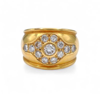 a close up of a gold and diamond ring on a white background