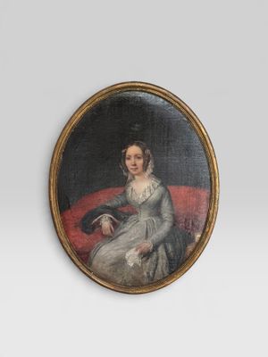 portrait of a lady seated on a red couch